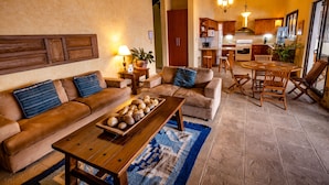 A cozy living room with a sofa, coffee table, and dining area. - Casa Cholotío lake view, modern, beach access (Panajachel)