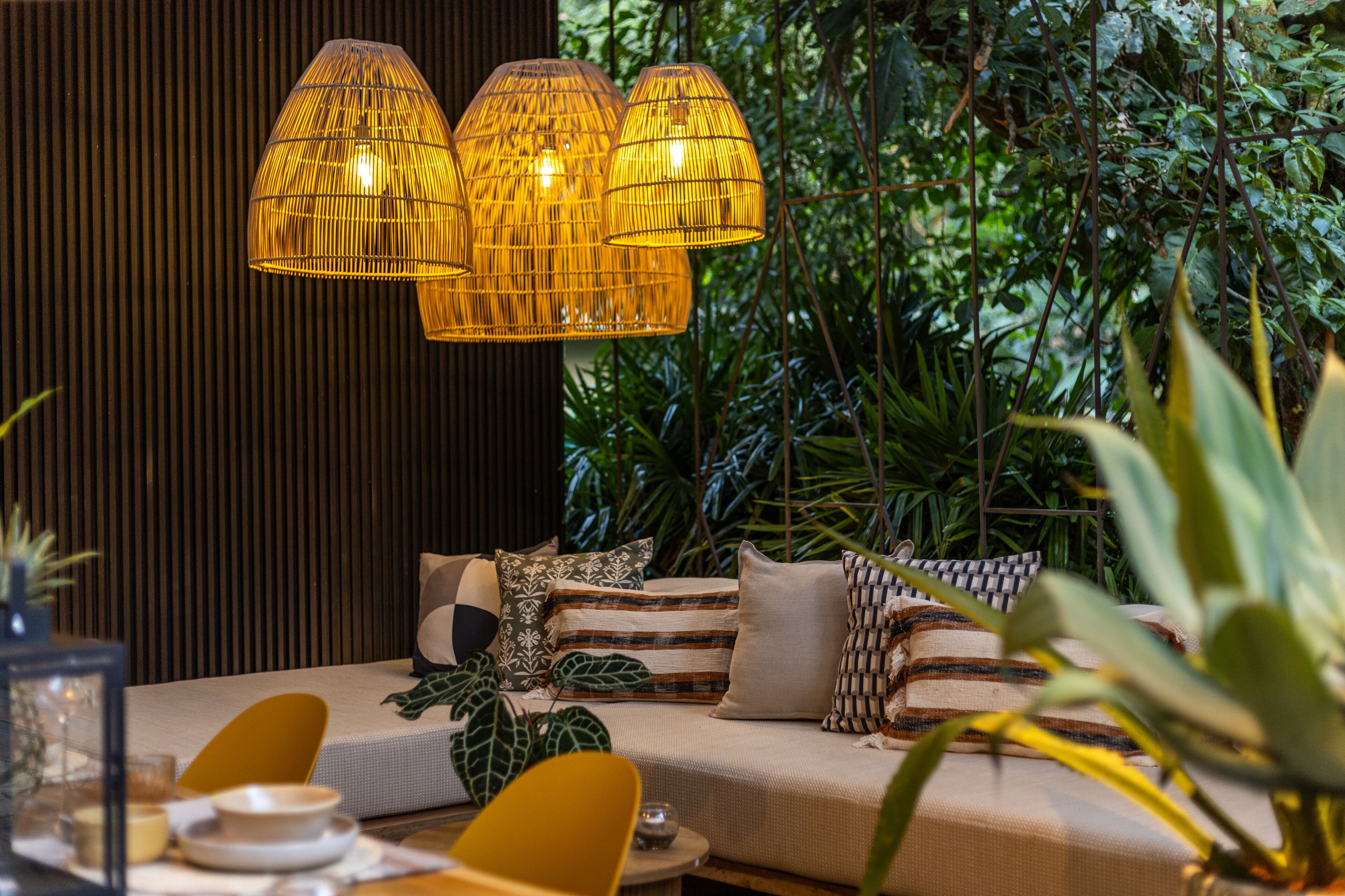 A cozy seating area with a sofa, cushions, and a table with a candle.