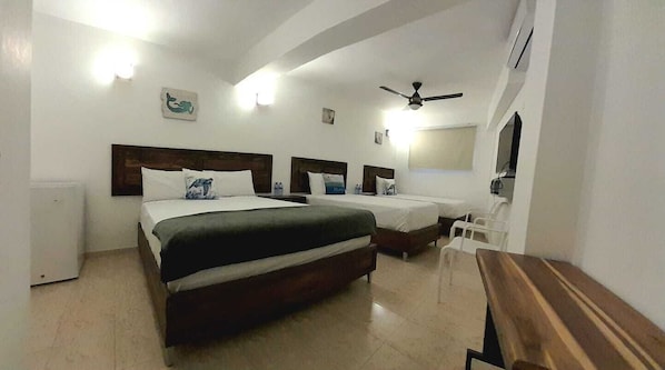 Family Triple Room | Pillow-top beds, free minibar, individually decorated