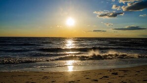 A beach with waves and a sunset. - Water Views - 3 Min Walk to Private Beach - Luxury 5-Star Rated Beach House (Lower Township)