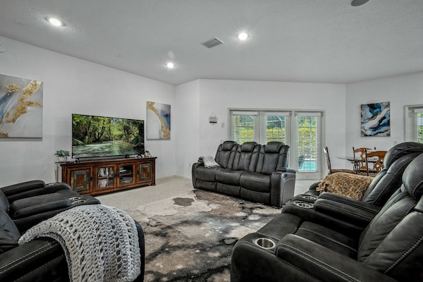 Open Living area with 65" Smart TV and French Doors to the pool and patio area.