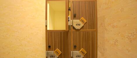 A wooden door with numbered lockers, each labeled with a number.