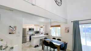 A modern kitchen with white cabinets, stainless steel appliances, and a central island. - Pocono Mountain Dream House with hot tub (Tobyhanna)
