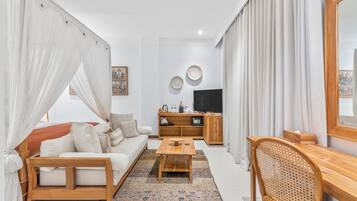 A modern living room with a sofa, coffee table, and a TV.