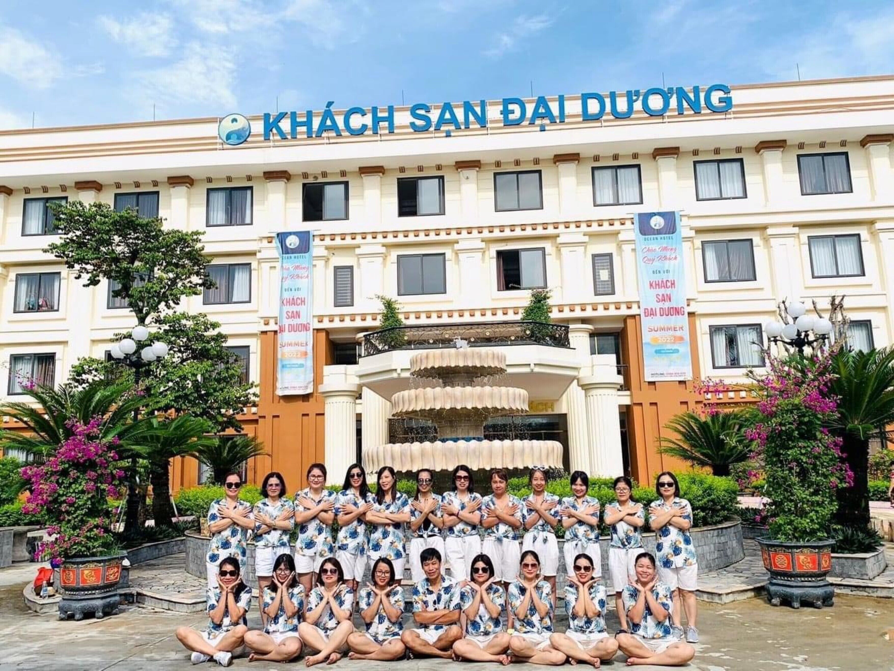 Un hôtel devant lequel se trouve un groupe de personnes. Le nom de l’hôtel est « KHÁCH SẠN ĐẠI DƯƠNG ».