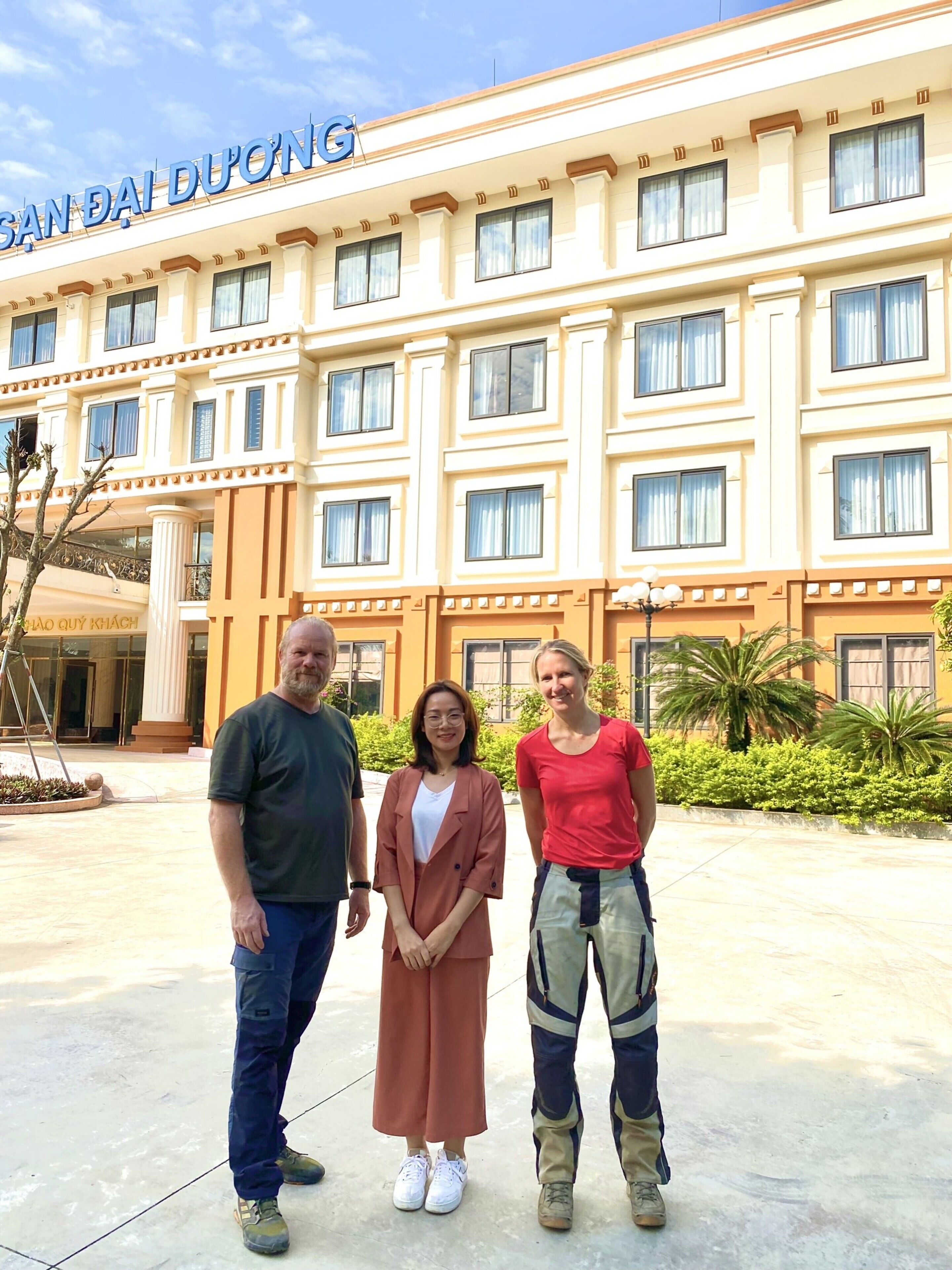 A hotel with a large sign reading "SAN DAI DUONG" and a modern architectural style with multiple windows and balconies.