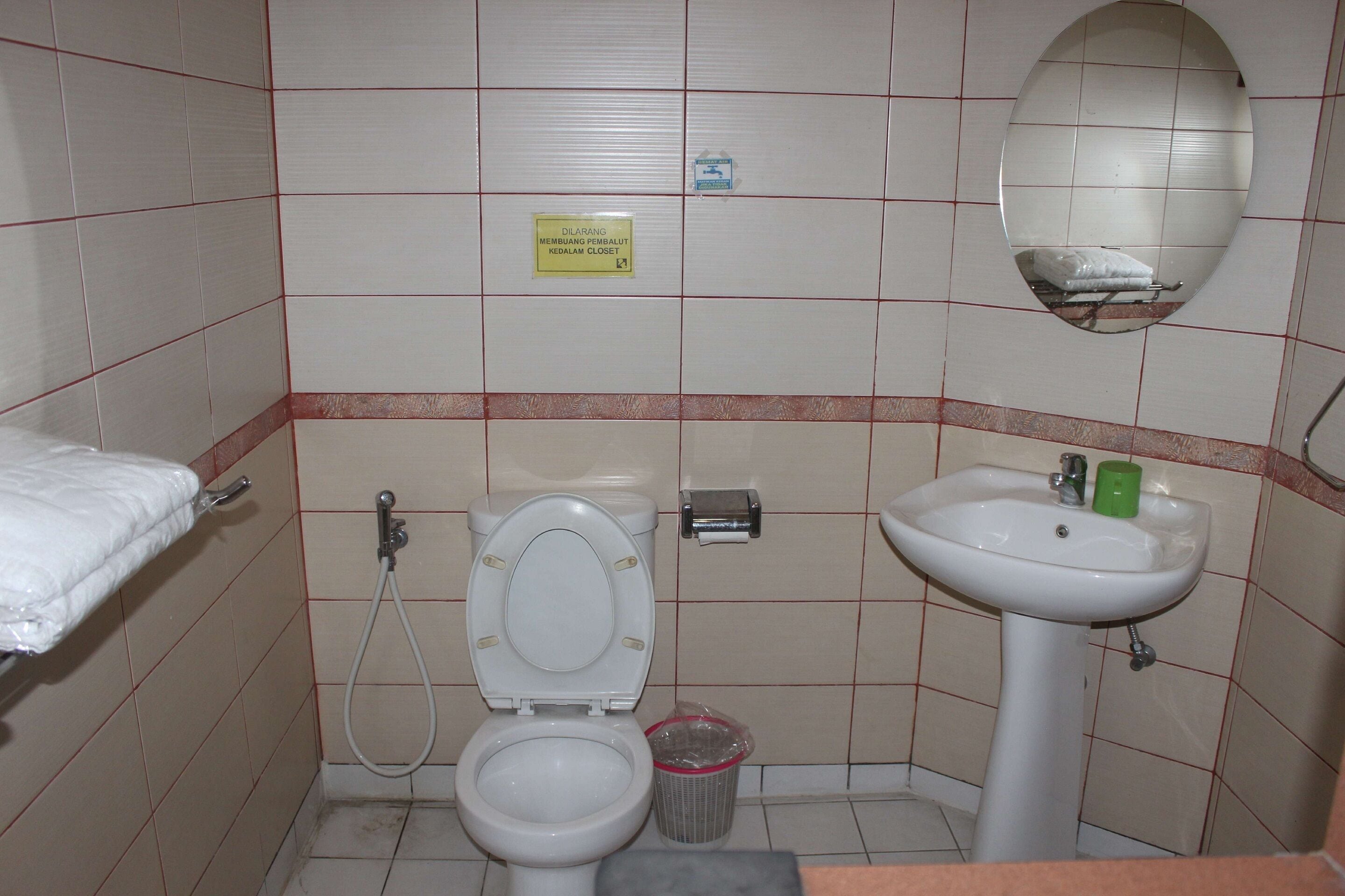 deluxe single room | bathroom | slippers, towels, soap, shampoo