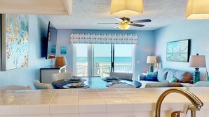 A modern bathroom with a large bathtub, a ceiling fan, and a view of the ocean through the sliding doors. - Oceanfront Top Floor Ocean Dunes, Bunk Room, Indoor/Outdoor Pools, Hot Tub, Tennis (Kure Beach)