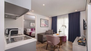 A compact living space with a kitchenette, a dining area, and a sofa. - The Belamy House Managed by HII  (Makati)
