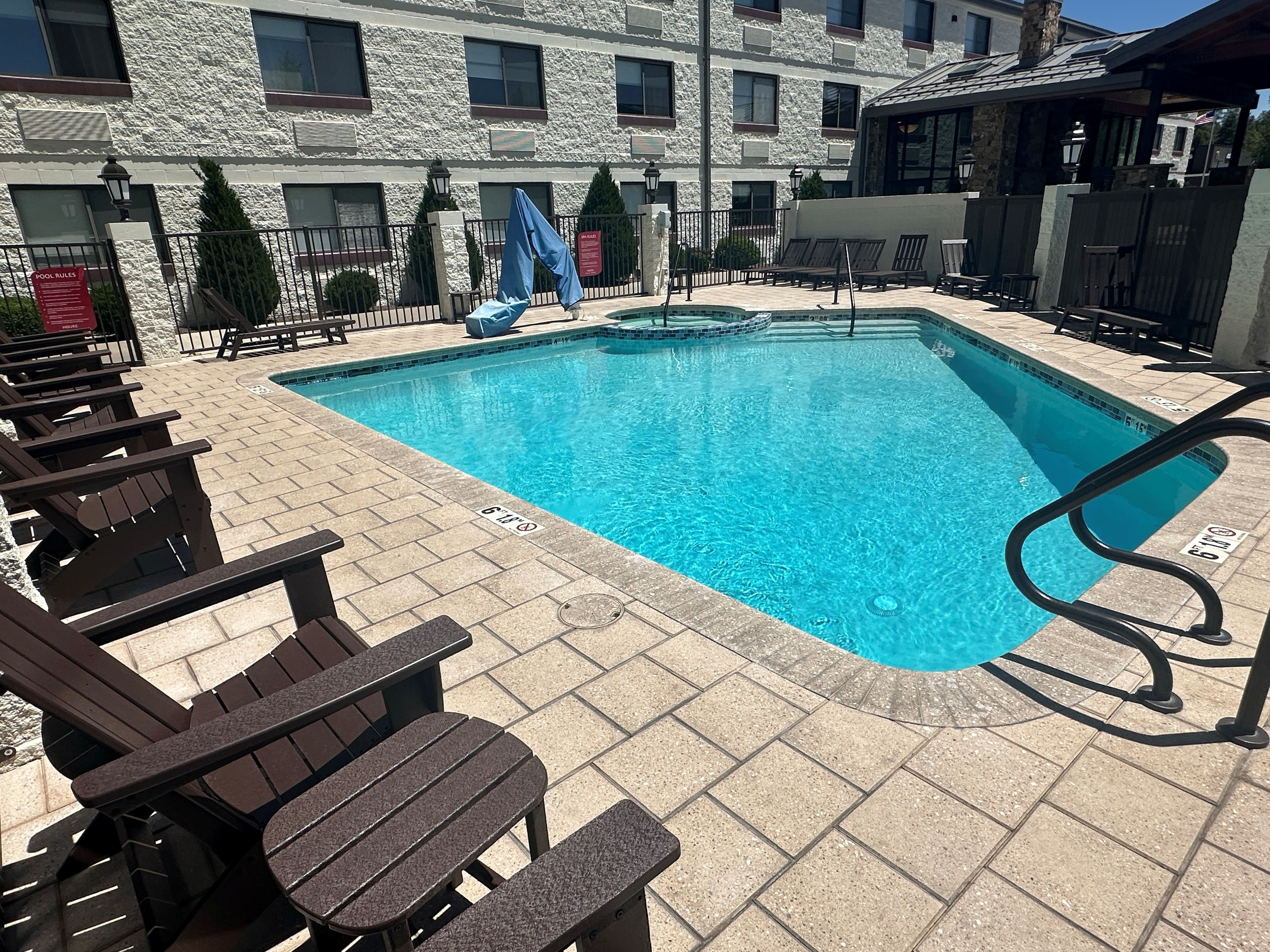 Dive into sunlit relaxation with sparkling pool and loungers.