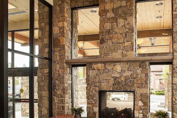 Unwind by the soaring stone fireplace in airy lobby.