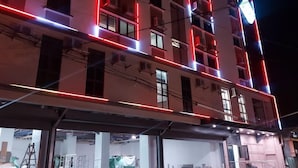 A multi-story building with illuminated red and white lines outlining the structure. - Fan's Hotel Ormoc (Ormoc)