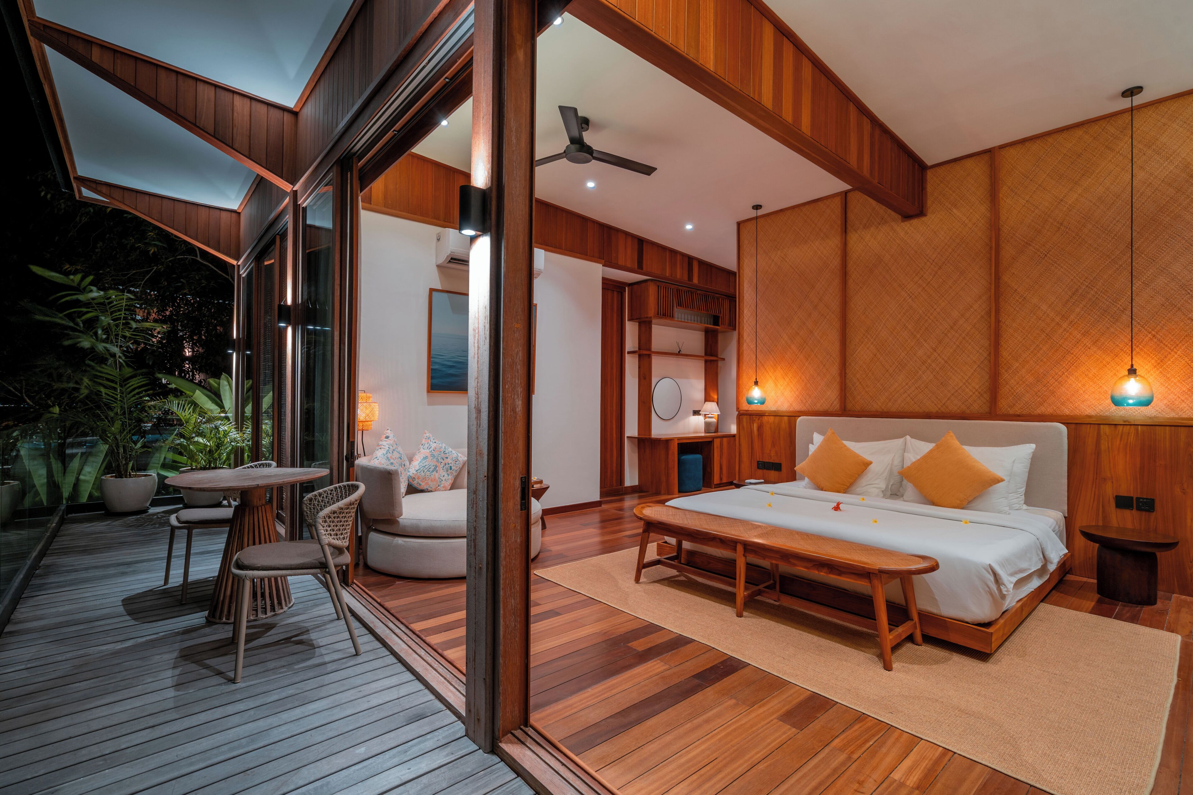 A modern bedroom with a large bed, bedside tables, and a view of the outdoors.