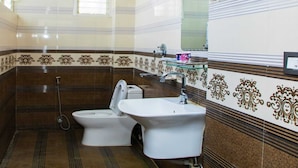 A bathroom with a toilet, bidet, and sink. - MeroStay004 (Kathmandu)