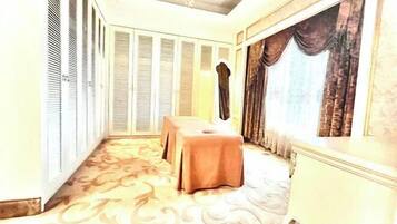 Classic design room with a long corridor, seating area, and large window.