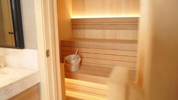 A sauna with wooden benches and a bucket with a brush.