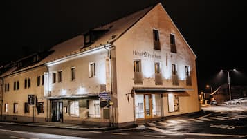 A hotel with a classic architectural design, featuring a prominent entrance and signage indicating its name.