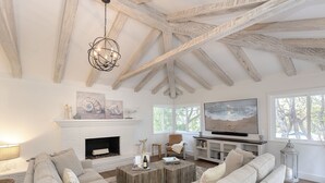 A spacious living room with a fireplace, comfortable seating, and a large TV. - 3877 Sea Esta~ Beautifully Remodeled, Near Golfing (Pebble Beach)