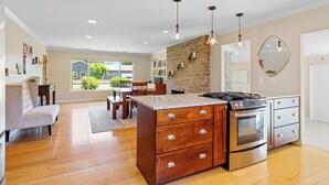 A modern kitchen with a central island, stainless steel appliances, and pendant lighting. - Wine Country Retreat w/ Pool, Hot Tub, Backyard & Game Nights Near Wineries (Santa Rosa)