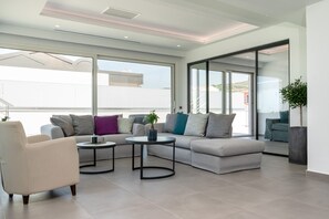 Athiri Suite | Living area | 40-inch Smart TV with satellite channels, TV, fireplace - Balia Suites (Corfu)