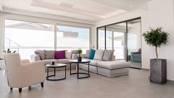 Athiri Suite | Living area | 40-inch Smart TV with satellite channels, TV, fireplace