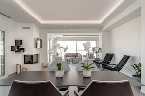 Athiri Suite | Living area | 40-inch Smart TV with satellite channels, TV, fireplace