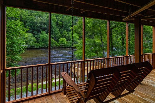 Log cabin with large decks on the Bank of the Tuckasegee River.