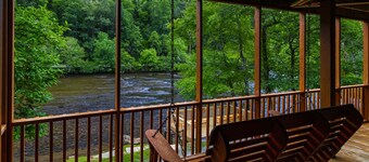 Log cabin with large decks on the Bank of the Tuckasegee River.