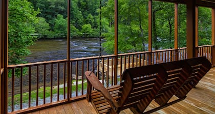 Log cabin with large decks on the Bank of the Tuckasegee River.