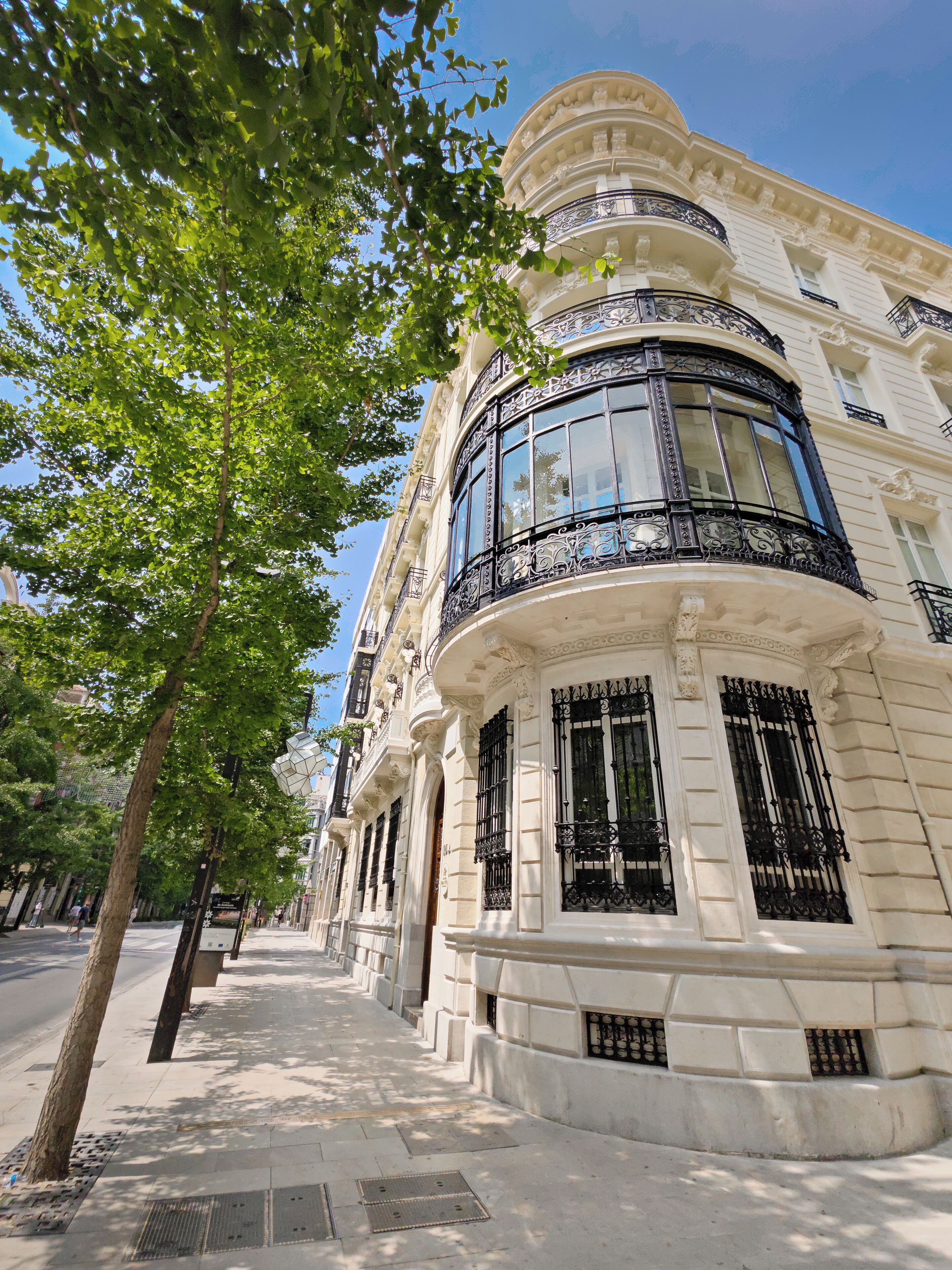 A historic building with ornate balconies and large windows.