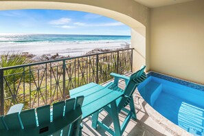 A balcony with a view of the beach, a pool, and a table with chairs. - Third Day*2Pools*Elevator*Loaded*Beach Service* (MIRAMAR BEACH)