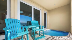 A poolside area with turquoise Adirondack chairs and a small pool. - The Brookie*OnBeach*BeachSvc*Elevator*2Pools (Miramar Beach)