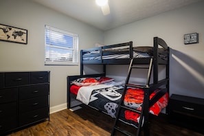 A bunk bed room with a world map on the wall, a dresser, and a window with blinds. - My old Kentucky Home  (Louisville)