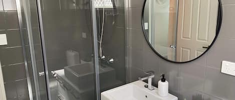 Shower, hair dryer, towels, shampoo