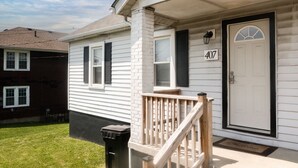 A residential house with a white exterior, black shutters, and a number 407 on the door. - Rustic Home w/ 2 BR - WIFI included (Louisville)
