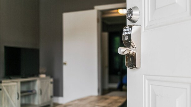 A white door with a combination lock and a keyhole. - Rustic Home w/ 2 BR - WIFI included (Louisville)