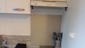 Una cocina moderna con encimera, pileta, alacenas y estufa.