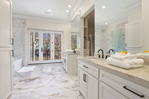 Bathtub, hair dryer, towels, shampoo