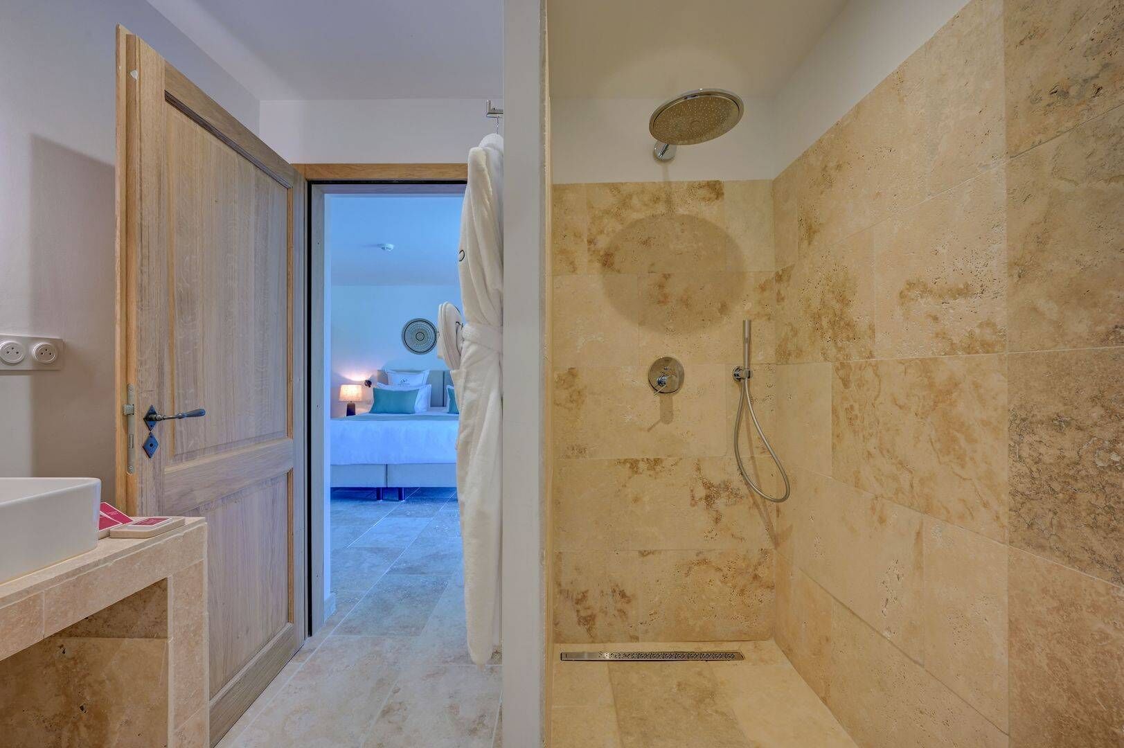 A bathroom with a shower, a toilet, and a sink.