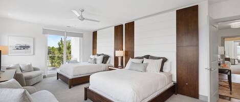 A modern hotel room with two beds, a sitting area, and a large window offering a view of the outdoors.
