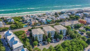 An aerial view of a coastal town with residential buildings, a beach, and a clear view of the ocean. - Villas at Seagrove by Panhandle Getaways (Santa Rosa Beach)