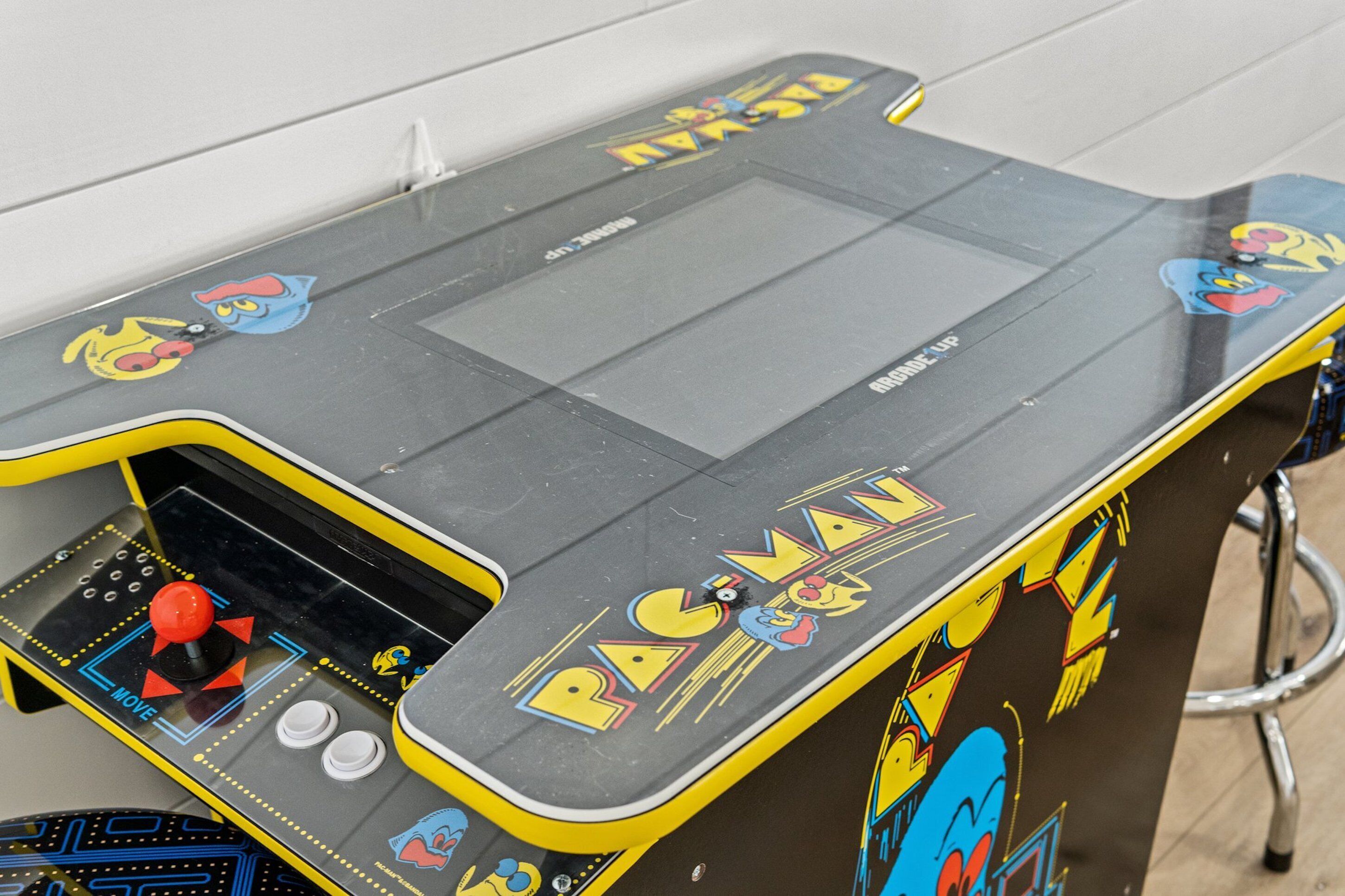 A Pac-Man arcade machine with a joystick and buttons.