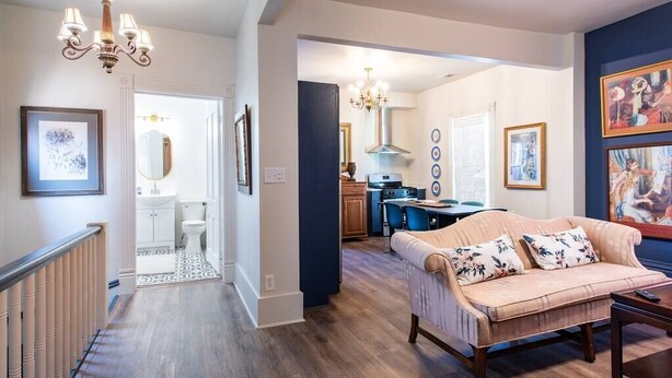 A spacious living room with a sofa, a dining area, and a kitchen. - The Gallery Loft - Walk & Dine! (Louisville)