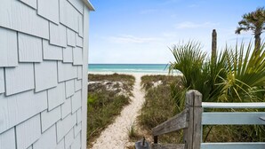 A beach path leading to the ocean, with a wooden fence and a building on the left. - Beach House - Family Tides by PHG (Panama City Beach)