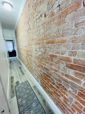 Stunning hallway with a patterned rug and a door leading to further exploration.
