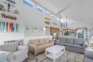 A spacious living room with two sofas, a coffee table, and a bookshelf.