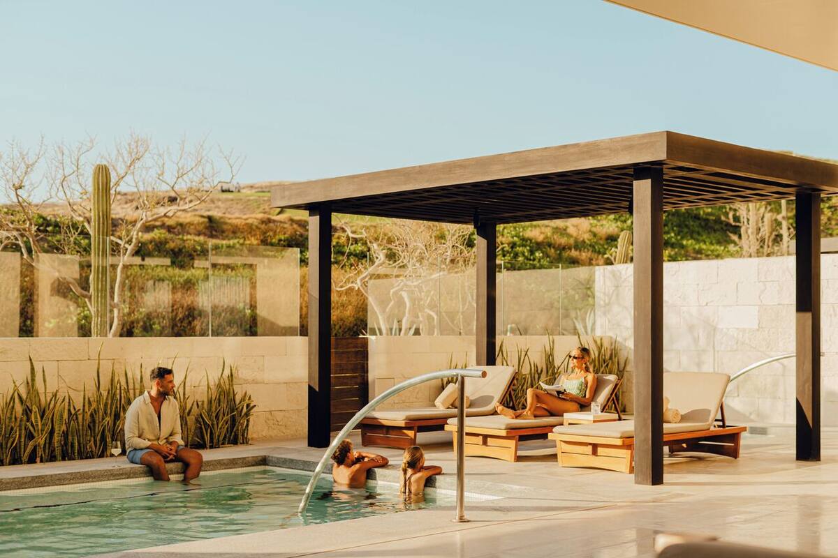 A poolside area with lounge chairs, a covered seating area, and a clear view of the surrounding landscape.
