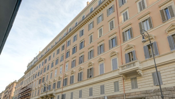 A multi-story building with a classic architectural style, featuring evenly spaced windows and balconies. - Voyager House (Rome)