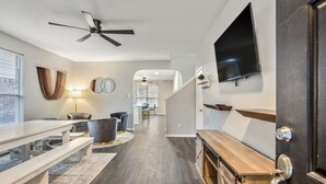 A modern kitchen with a wooden countertop, a built-in oven, and a large window. - Stylish 8-Guest Getaway with Fire Pit & Modern Comforts (Spring)