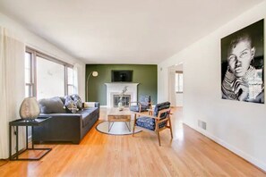 Relax in this stylish living room with a sofa, coffee table, and fireplace, perfect for unwinding.